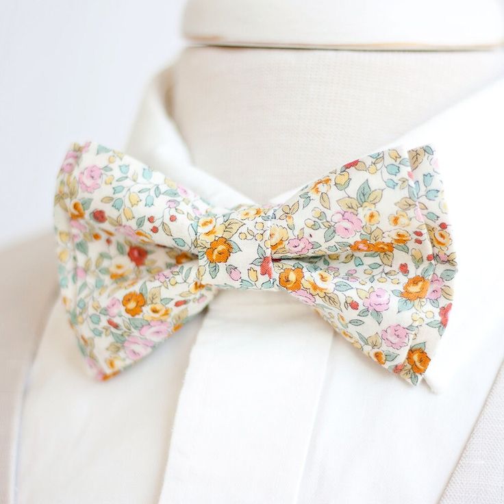 a bow tie on a white shirt with flowers