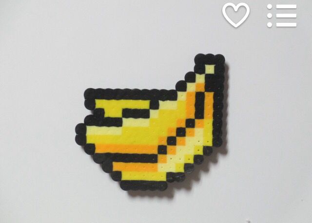 a yellow and black pixelated chicken brooch on a white background with the words i love it