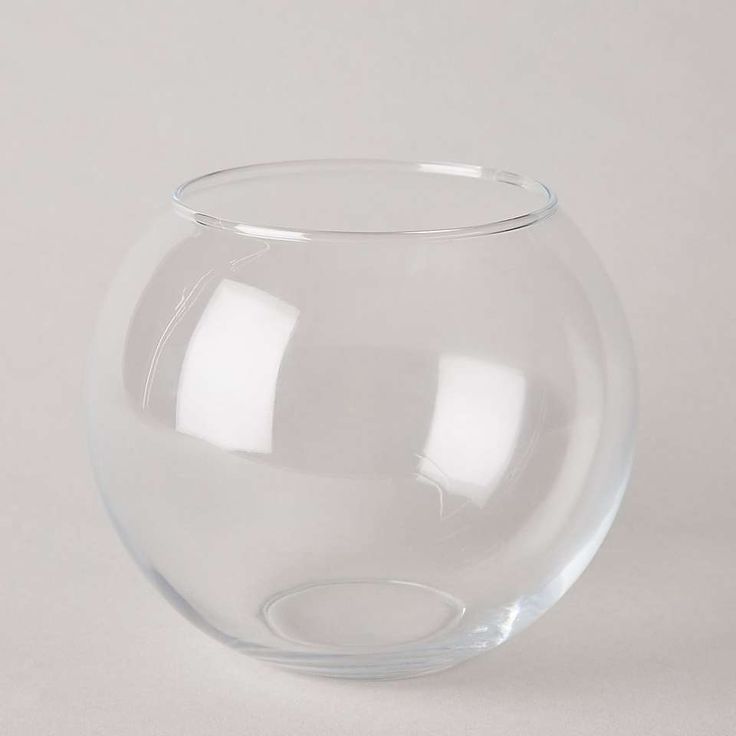 a clear glass bowl sitting on top of a white table