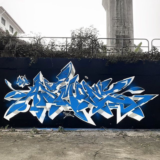 blue graffiti on the side of a building