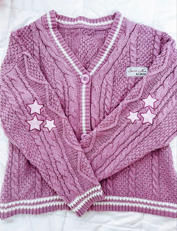 a purple sweater with pink stars on it