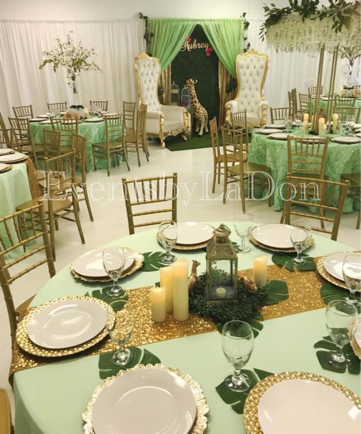 a table set up with plates, candles and place settings for an elegant dinner party