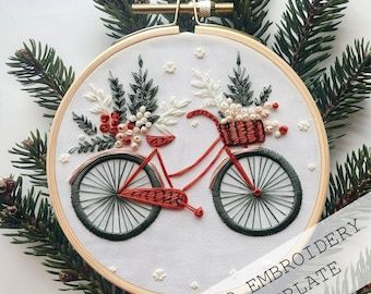 a red bicycle with christmas decorations on it is hanging from a pine tree and has a ribbon in front of it