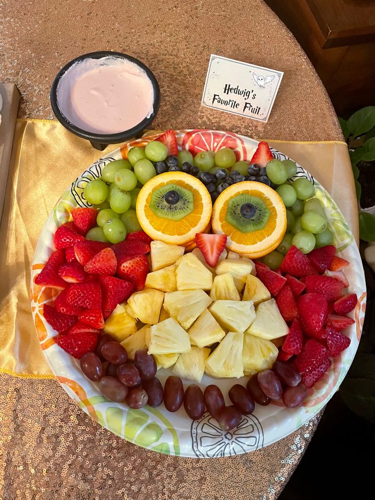 a plate topped with fruit and an owl face