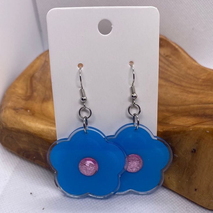 Handmade Blue Daisy Flower Earrings Silver Hook Earrings Blue/Purple Center Made in the USA Blue Flower Charm Drop Earrings, Trendy Light Blue Drop Earrings, Trendy Blue Flower Earrings, Trendy Light Blue Dangle Earrings, Trendy Blue Flower Shaped Jewelry, Blue Flower Earrings For Pierced Ears, Trendy Blue Dangle Earrings, Blue Flower Earrings Nickel Free, Resin Dangle Flower Earrings With Flower Charm