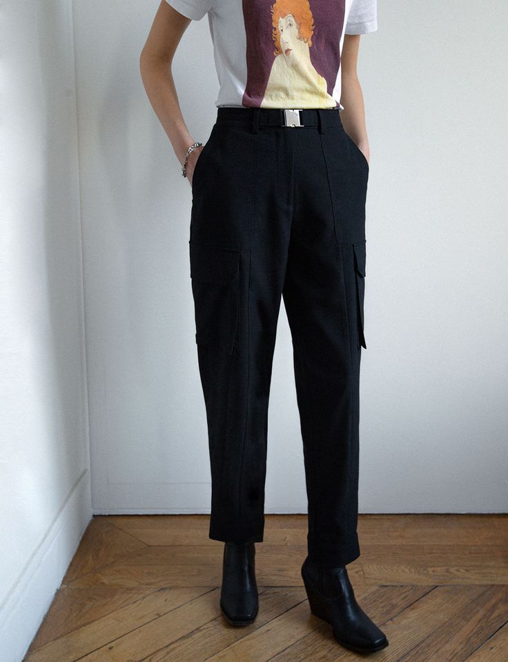 Chic black cargo pants with metal belt clip and multi utility pockets . Brand Pixie Market67% Polyester, 23% Rayon, 8% Wool, 2% elastaneAdjustable snap button ankle cuffSize XS waist 24.5"/ hips 34.5"Size S waist 26.5"/hips 36.5"Size M waist 28.5", hips 38.5"Size L waist 30.5", hips 40.5'Total length 39"/ 101 cmInseam 28"/71 cmModel is wearing a size S and model's height is 5.9"/175 Fitted Cargo Jeans With Belt Loops For Work, Workwear Cargo Pants With Multiple Pockets Ankle-length, High Waisted Cargo Pants With Flap Pockets For Workwear, Black Utility Bottoms With Belt Loops, Utility Black Bottoms With Belt Loops, Utility Cargo Pants With Belt Loops For Workwear, High Waist Cargo Pants With Cargo Pockets For Work, Straight Leg Techwear Bottoms For Workwear, Techwear Tapered Leg Pants For Work