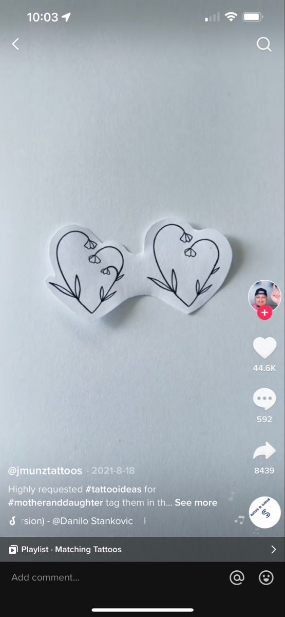 two heart shaped stickers on top of a white surface with the words love written in it