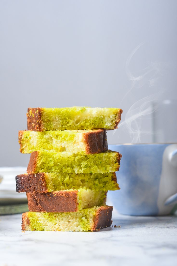 three pieces of bread stacked on top of each other in front of a blue cup