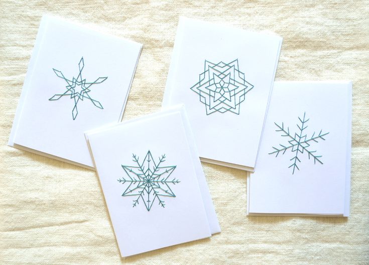 four cards with green ink on white paper