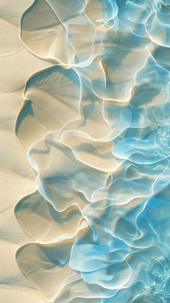 an aerial view of water and sand in the ocean, with ripples on it