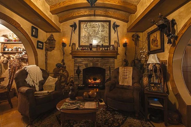 a living room filled with furniture and a fire place in the middle of an archway