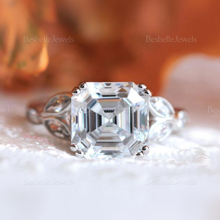 an emerald cut diamond ring with three side stones