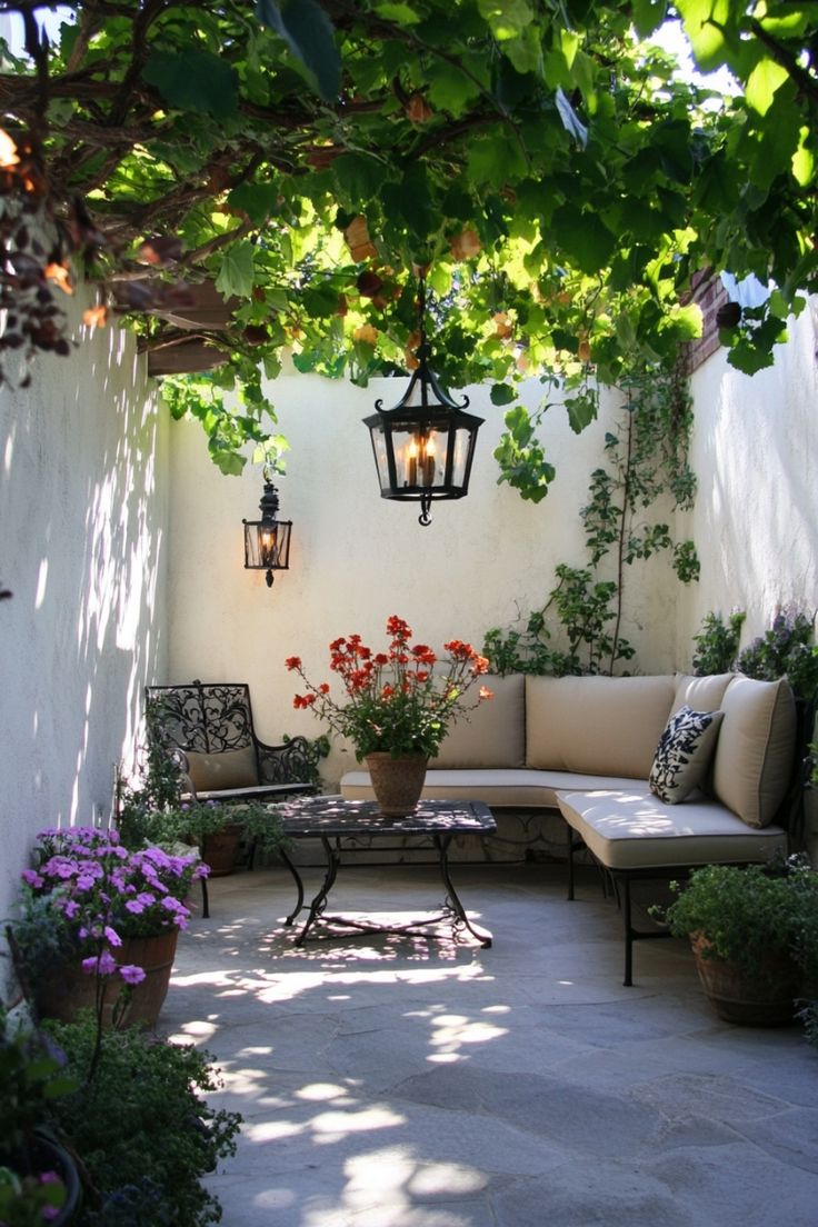 Outdoor patio with a cozy seating area, lush plants, and hanging lanterns.