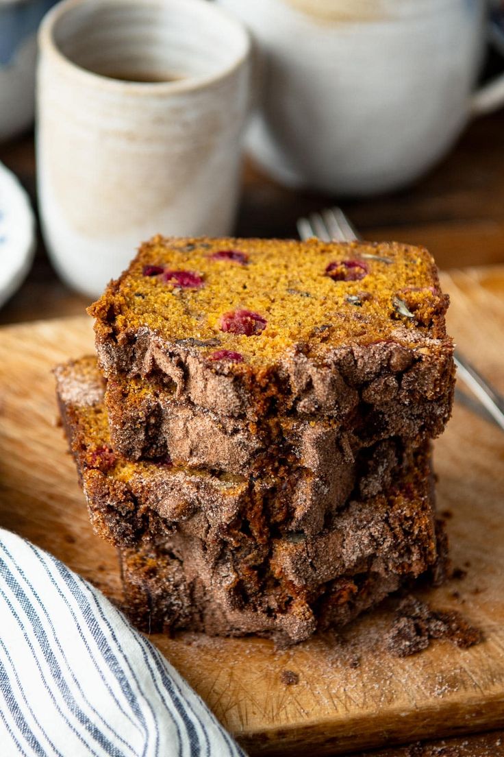 a close up of a piece of cake on a wooden cutting board with a fork