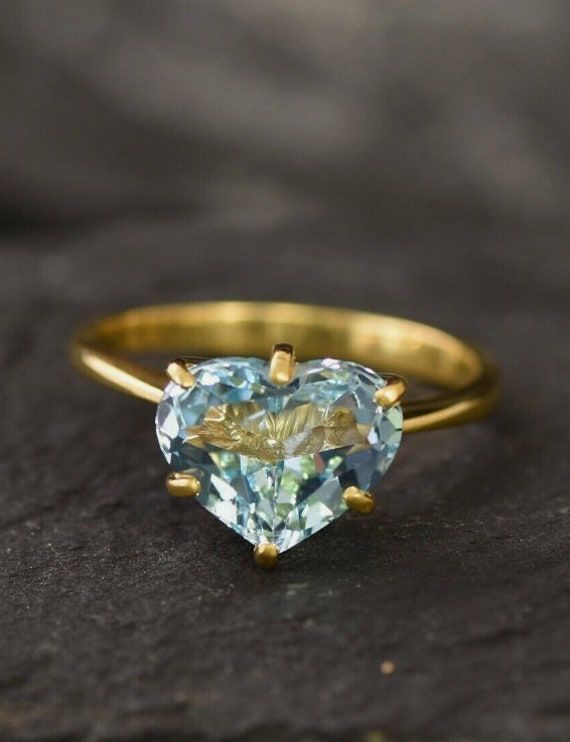 Heart Shaped Aquamarine Gemstone Ring / 14k Yellow Gold Ring / Best Valentine Gift For Girlfriend / Gold Gemstone Ring / Handmade Gold Ring by Shomilijewellers Details :- Handmade Item Material :- 14k Yellow Gold Gemstone :- Aquamarine  Ring Size: 7 US and we can make ring size as per your requirement size. Gold Gemstone Heart Ring For Promise, 14k Gold Heart-shaped Proposal Jewelry, 14k Gold Heart Cut Jewelry With Center Stone, Gold Gemstone Crystal Proposal Ring, Gold Crystal Proposal Ring With Gemstone, Gold Crystal Proposal Ring, Gold Ring With Gemstone In Heart Cut, Gold Heart Cut Gemstone Ring, Yellow Gold Gemstone Jewelry For Proposal