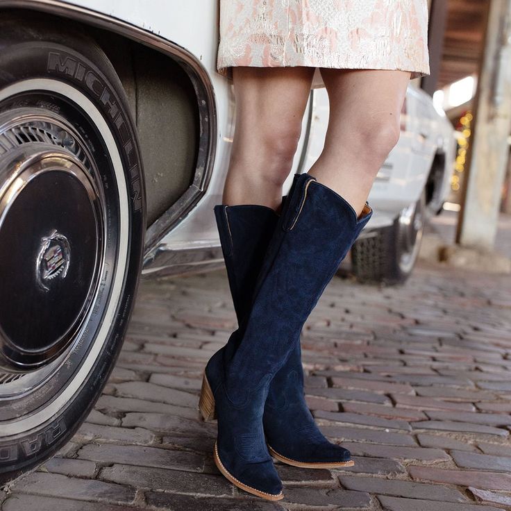 Indulge in a bold and enchanting world with these luxurious navy blue suede boots. Meticulously crafted with eye-catching cut-out details, the knee-high silhouette is adorned with intricate braiding along the shaft collar. Equipped with sturdy side pull tabs, these boots boast a classic Western timeless and chic silhouette. Model: L3166-11 Color: Navy Blue Shaft Height: 17" Leather: Suede Blue Suede Boots, Wedding Boots, Summer Boots, Signature Collection, Blue Suede, Tall Boots, Short Boots, Boot Shop, Suede Boots