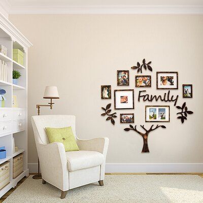 a family tree is mounted on the wall above a chair in a room with white carpet