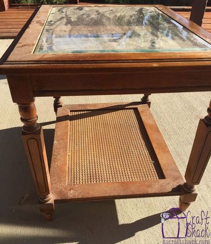 an old wooden table with glass top