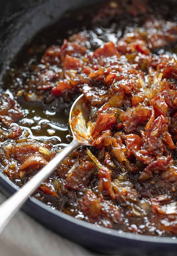 a pan filled with food and a spoon in it