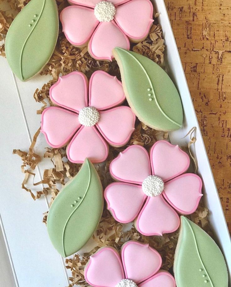 decorated cookies in the shape of flowers and leaves