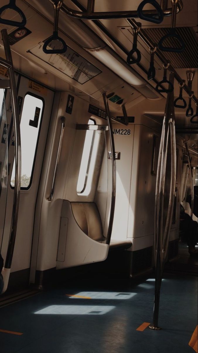 the inside of a subway car with its doors open and sunlight shining in through the windows