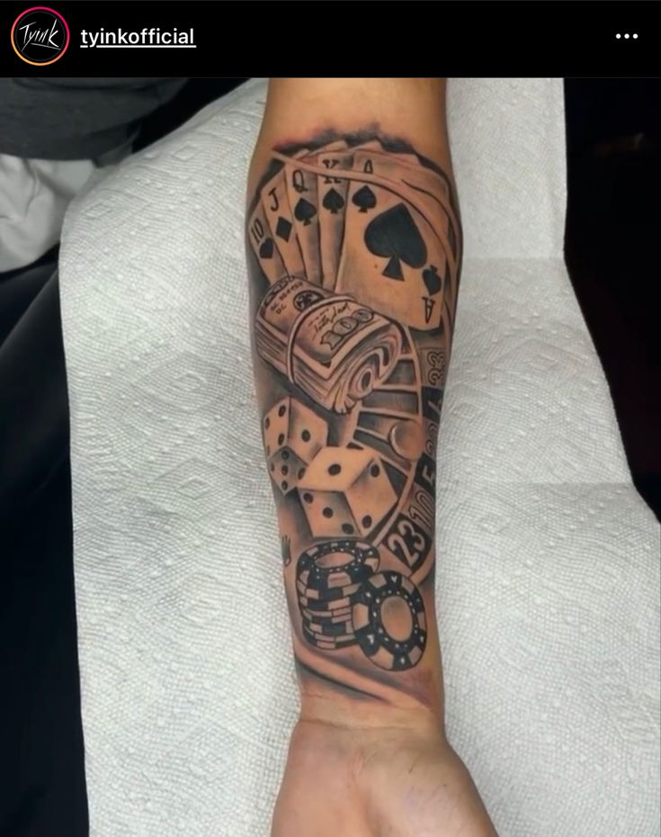 a person with a tattoo on their arm holding up a hand full of playing cards