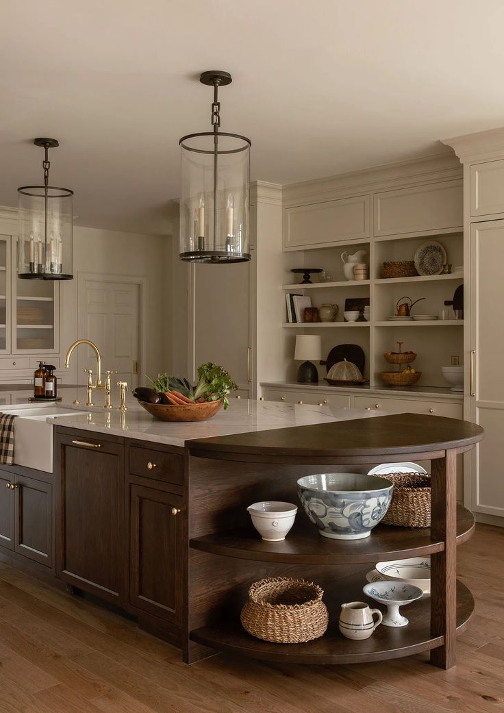 a large kitchen with an island in the middle and lots of bowls on top of it