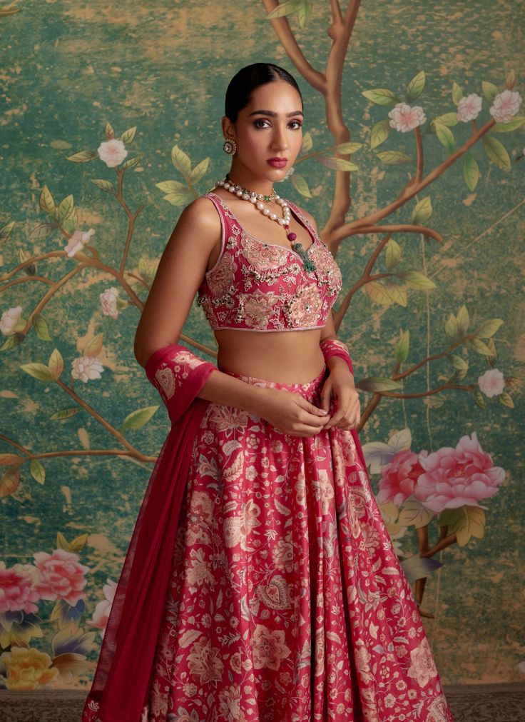 Step into sophistication with this lehenga set featuring a net embroidered applique blouse paired effortlessly with a printed raw silk lehenga and a net dupatta adorned with organza ruffles. The ensemble is a masterpiece of intricate embroidery, boasting beautiful pearls, green stones, and detailed threadwork. Perfect for special occasions and celebrations, this lehenga set seamlessly combines traditional craftsmanship with contemporary design. The net dupatta with organza ruffles and border emb Print Lehenga, Applique Blouse, Ridhi Mehra, Raw Silk Lehenga, Green Stones, Silk Lehenga, Net Dupatta, Embroidered Applique, Intricate Embroidery