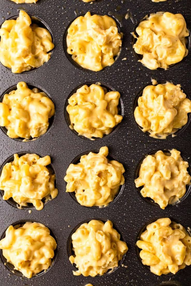 muffins filled with macaroni and cheese on a baking sheet