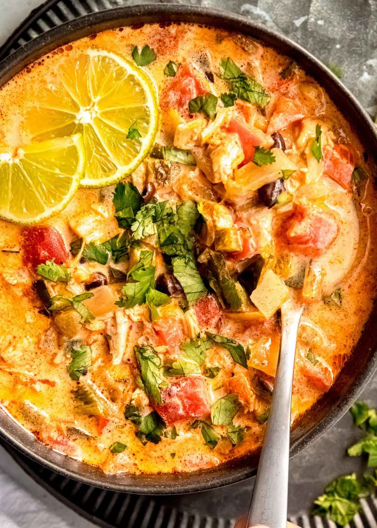 a skillet filled with food and garnished with cilantro, limes, and parsley