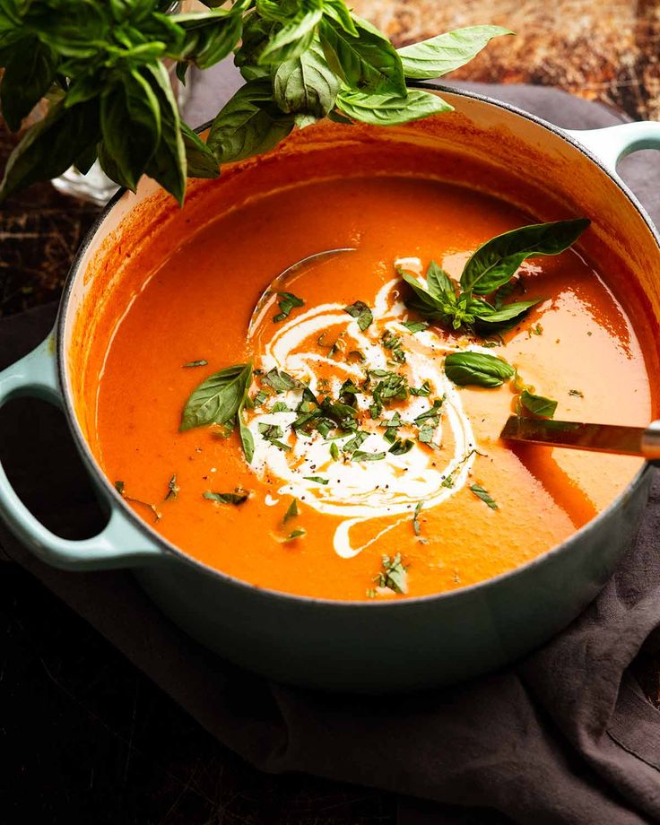 a pot filled with soup and garnished with herbs