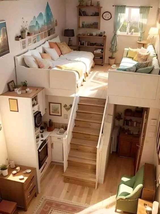 an overhead view of a living room with stairs leading up to the bedroom and kitchen