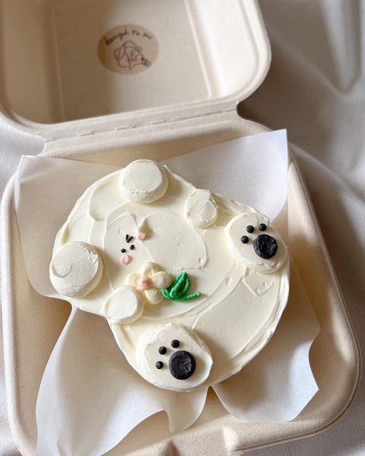 there is a cake in the shape of a polar bear with green leaves on it