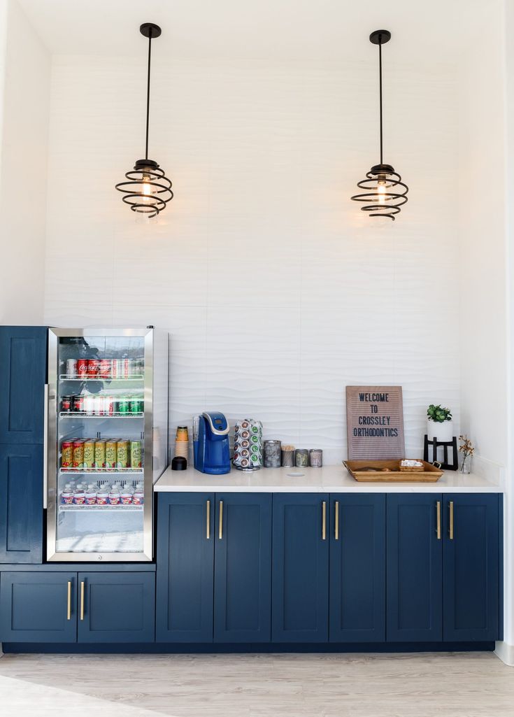 an ice cream shop with blue cabinets and hanging lights