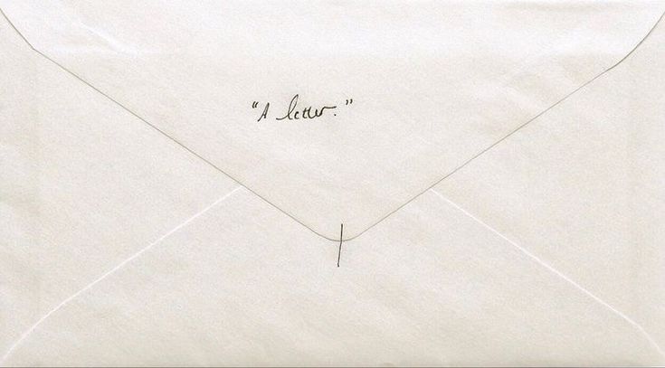 an envelope with writing on the front and inside is open to reveal a letter that has been written in cursive ink