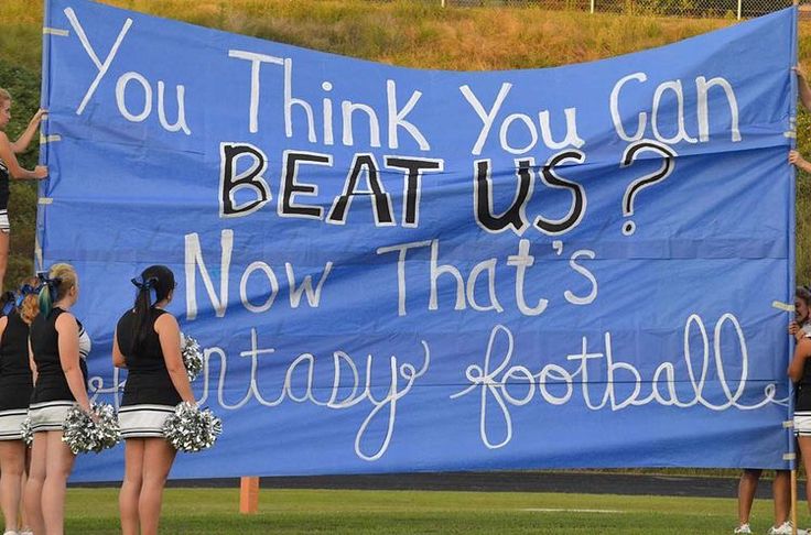 some cheerleaders are standing in front of a sign that says, you think you can beat us now that's fantasy football