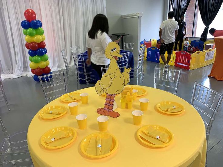 there is a table set up with plates and cups for children to play in the room