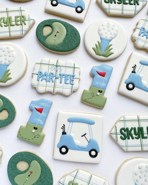 decorated cookies are arranged on a white surface with green and blue lettering that says, golf