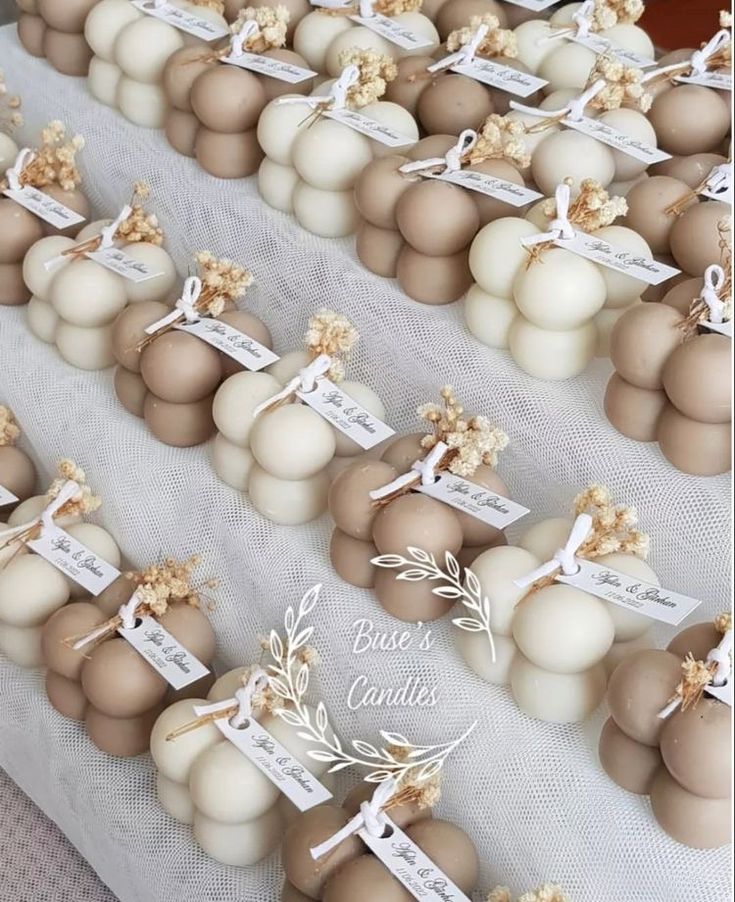 there are many brown and white eggs on the table with name tags attached to them