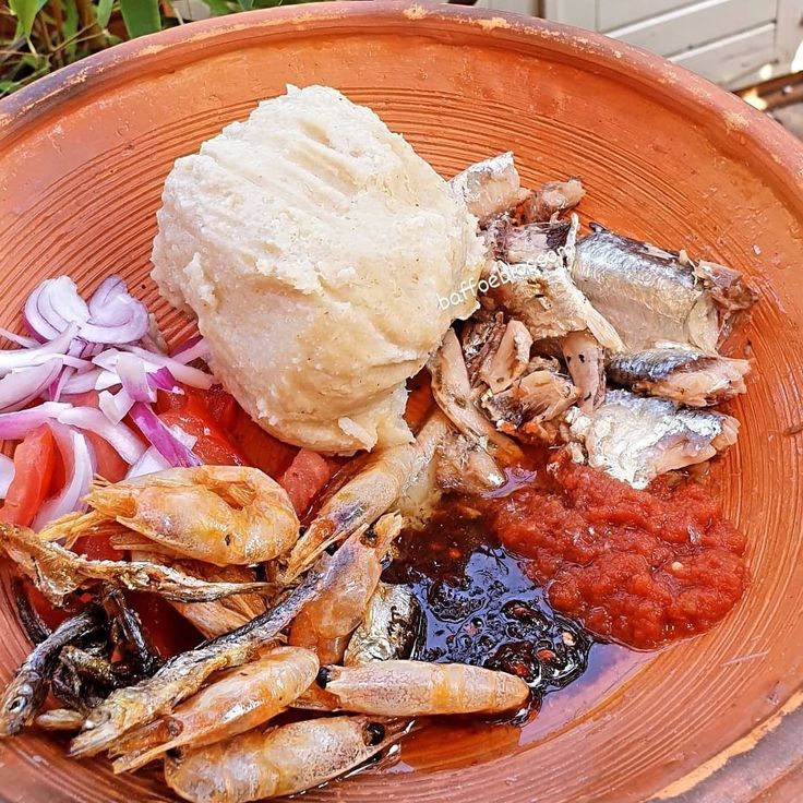 an orange bowl filled with different types of food