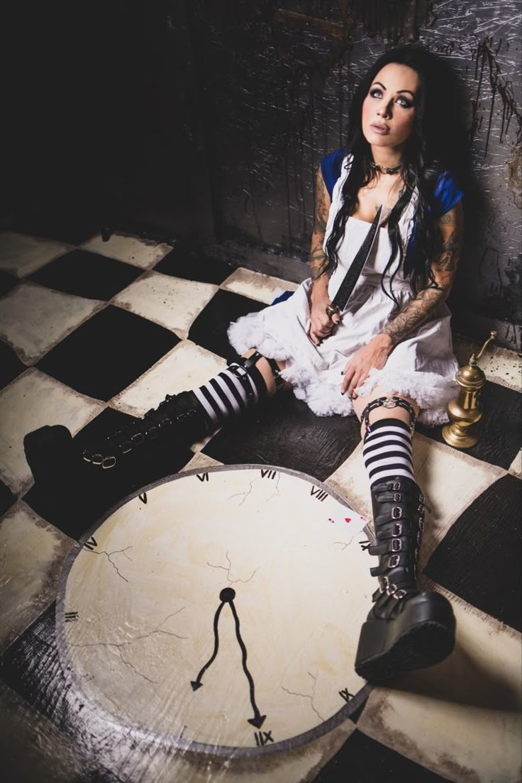 a woman sitting on top of a table wearing black and white socks with her legs crossed