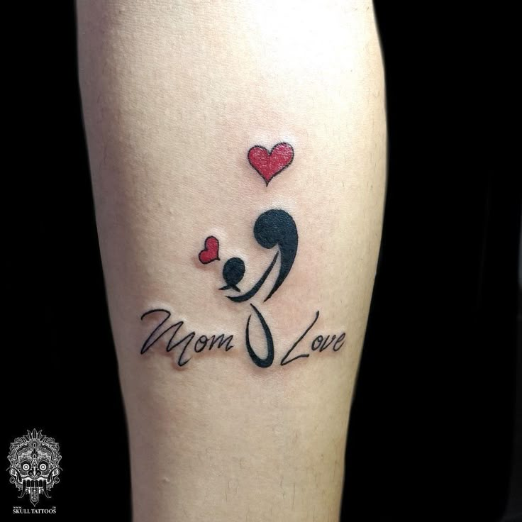 a woman's leg with a tattoo that says mom love and a dog holding a heart