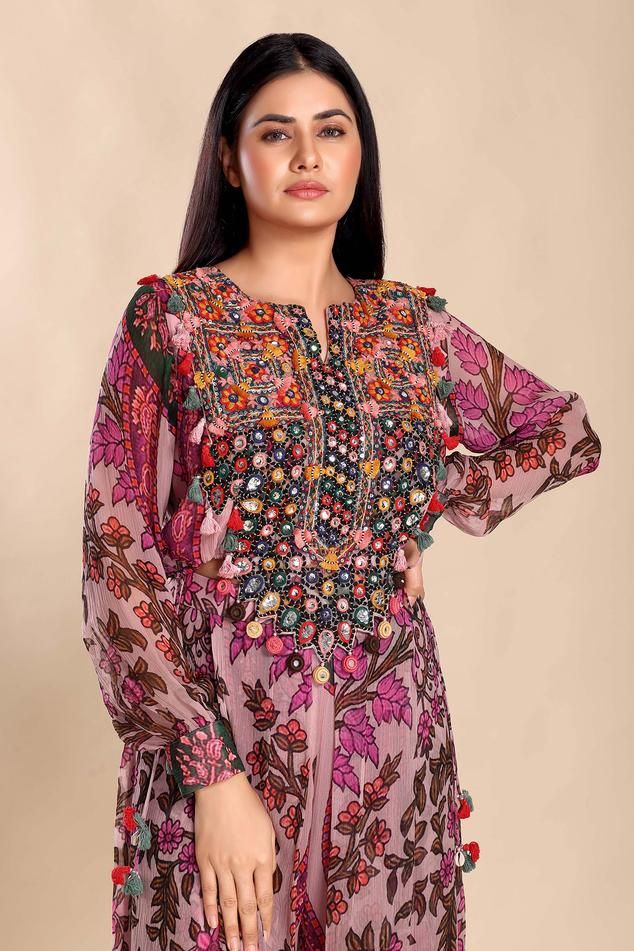 Multicolored floral print top comes with folkore embroidery, and cuff sleeves. Paired with a box pleat sharara.
Components: 2
Pattern: Embroidered
Type Of Work: Thread, Bead
Neckline: Notched
Sleeve Type: Long
Fabric: Chiffon
Color: Multi Color
Other Details: 
Attached lining
Length:
Top: 16 inches
Sharara: 42 inches
Approx. product weight: 1 -3 kgs
Model Height: 5 ft. 8 inches, wearing size M
Occasion: Resort - Aza Fashions Bohemian Tops With Intricate Embroidery For Navratri, Traditional Floral Print Tunic Top, Bohemian Tops For Festive Transitional Season, Traditional Tops With Mirror Work For Spring, Multicolor Georgette Blouse With Mirror Work, Bohemian Straight Kurta Tops For Festive Occasions, Long Sleeve Blouse With Floral Embroidery For Navratri, Navratri Long Sleeve Blouse With Floral Embroidery, Traditional Spring Tops With Mirror Work