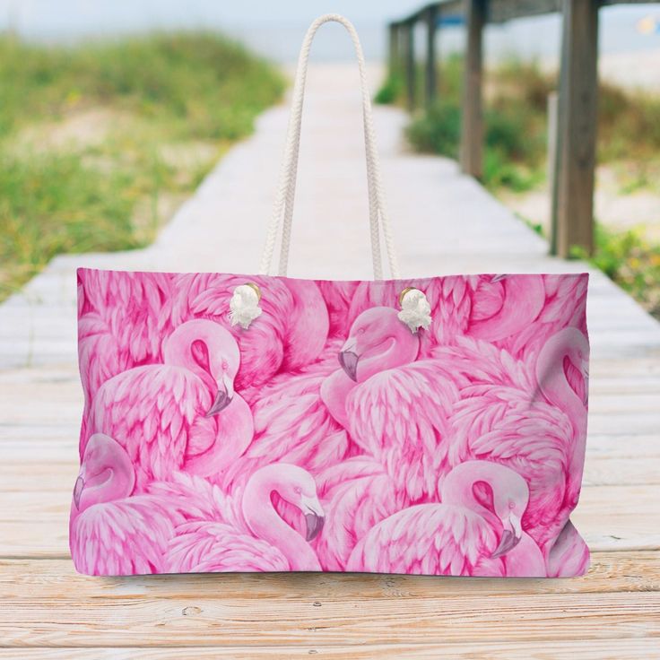 "Our oversized Weekender Pink Flamingo Tote is perfect for your weekend at the beach or in town. The wide-mouthed, durable bag holds a generous amount of personal items and is easily held by its thick rope handles. Stylish gift idea. .: 100% Spun Polyester .: T-bottom .: Cream sheeting interior lining .: One size: 24\" x13\" (60.9 cm x 33 cm) .: Handle height, in 11.42, cm 29.00 .: NB! Size tolerance 0.75\" (1.9 cm)) Care instructions: Before cleaning the bag, remove all the items from the bag. Pink Tote Beach Bag For Weekend, Large Capacity Beach Bag For Summer Weekend, Pink Rectangular Beach Bag For Weekend, Pink Rectangular Canvas Bag For Weekend, Pink Rectangular Beach Bag For Beach Season, Rectangular Pink Beach Bag For Vacation, Large Capacity Pink Summer Beach Bag, Pink Large Capacity Beach Bag, Summer Large Capacity Pink Beach Bag