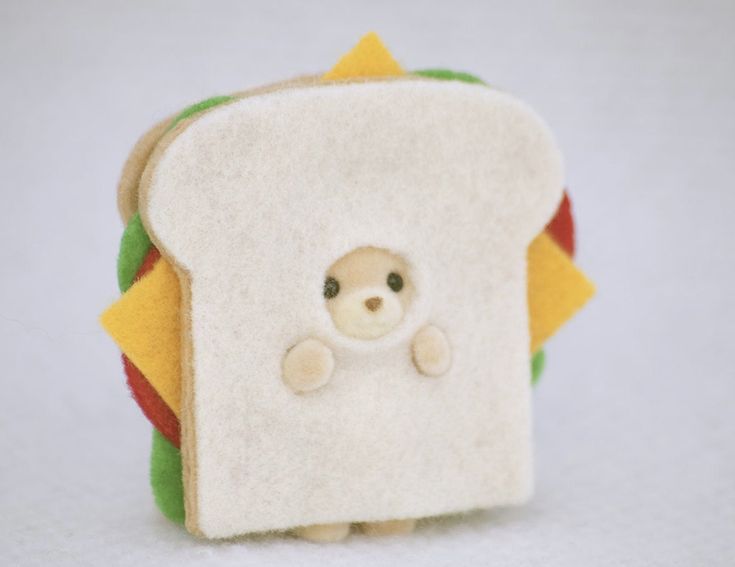 a stuffed animal is peeking out of a sandwich