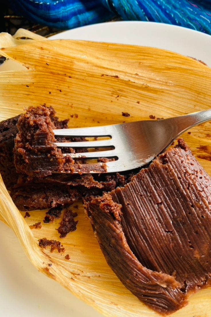 a fork is stuck into some brownies on a plate