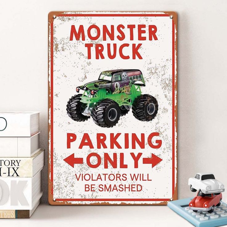 a monster truck parking only sign on a shelf next to some books and a toy