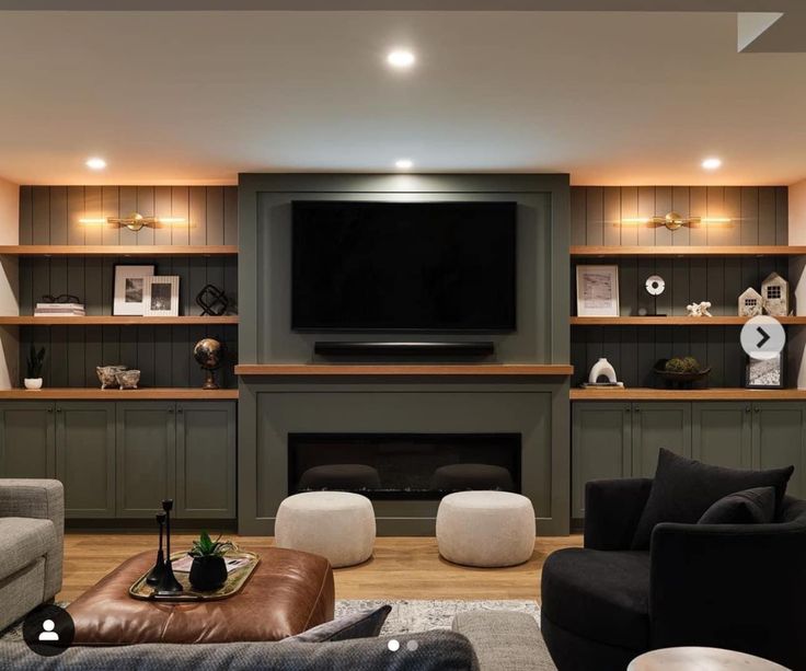 a living room filled with furniture and a flat screen tv mounted on the wall above a fireplace