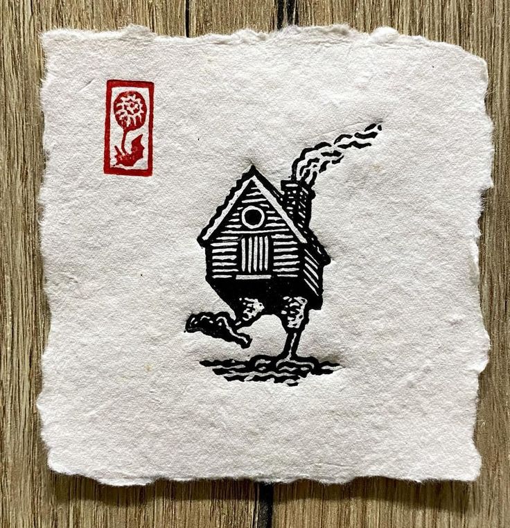 a piece of paper with an image of a house on it and a stamp in the shape of a bird