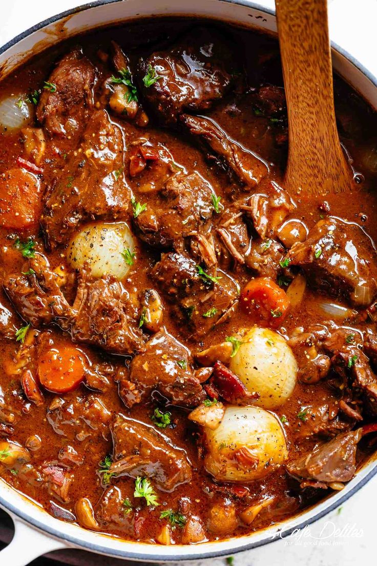 beef stew with potatoes and carrots in a large pot, ready to be eaten